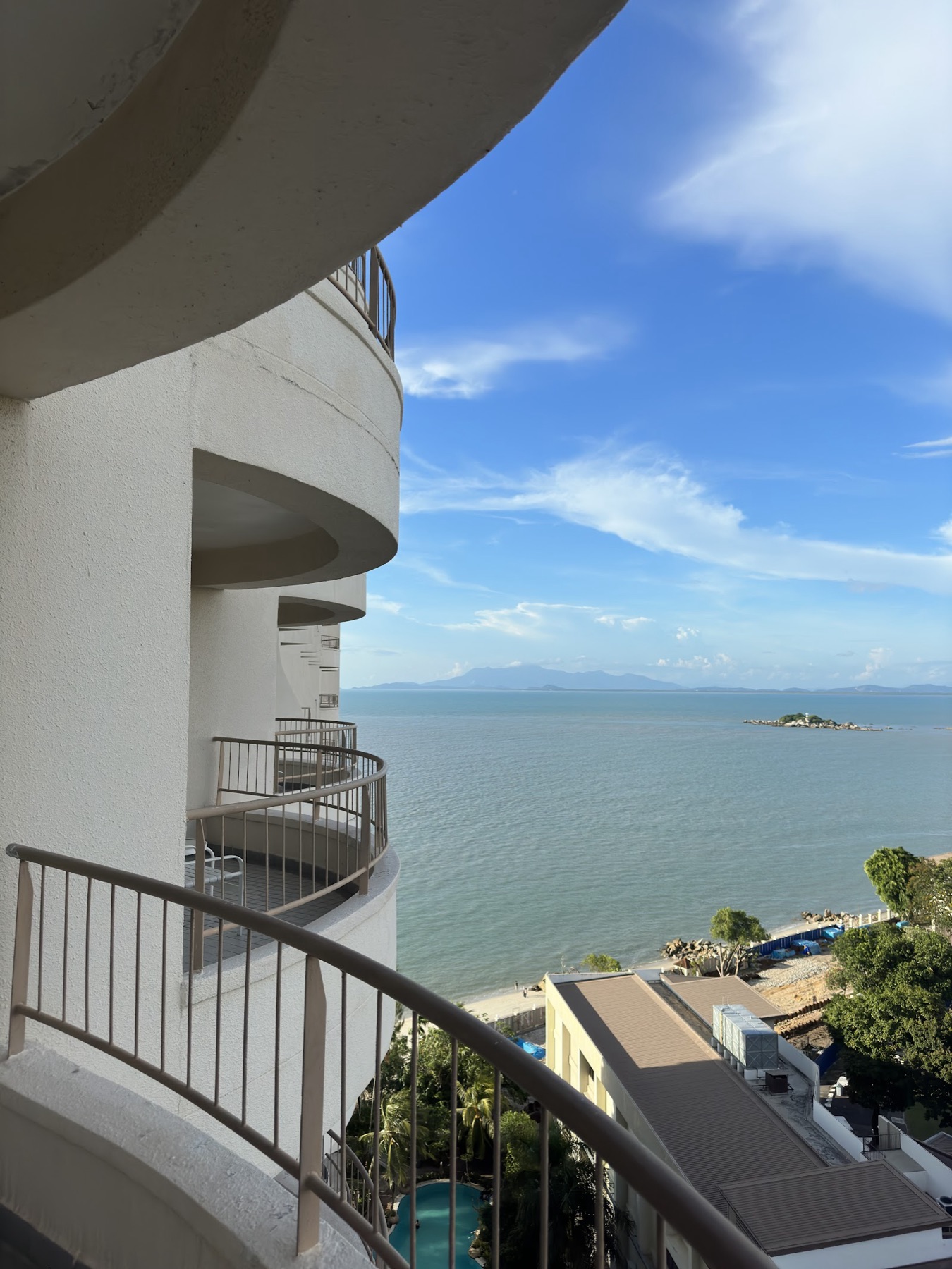 Sea-view balconies of Rainbow Paradise Beach Resort overlooking the turquoise Penang strait at Tanjung Bungah